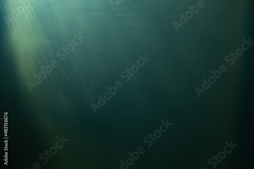 green background of dark wall illuminated by electric light