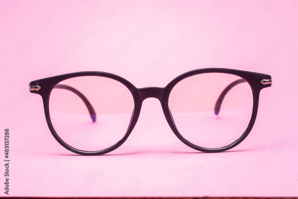 Stylish glasses on a pink background close-up. Stylish glasses on a pink background close-up.