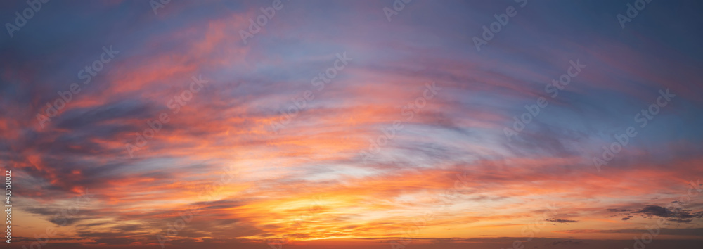 dramatic vibrant sunset in red hues with cirrus clouds