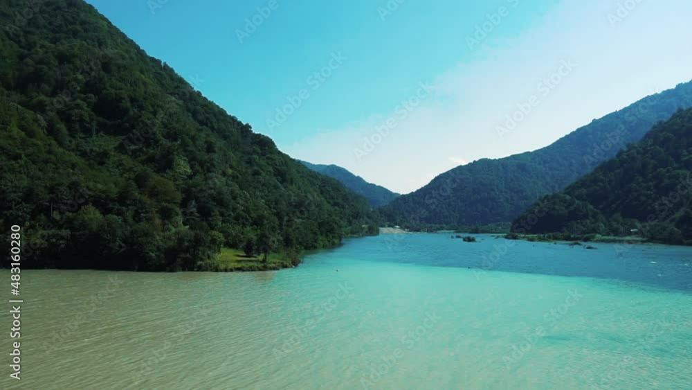 Turquoise water in a mountain forest lake with pine trees. View of blue lake and green forests. View on the lake between mountain forest. Over crystal clear mountain lake water. Fresh water Turquoise water in a mountain forest lake with pine trees. View of blue lake and green forests. View on the lake between mountain forest. Over crystal clear mountain lake water. Fresh water