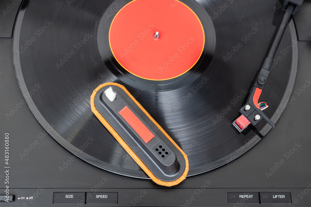 Cleaning tool on vinyl record. Cleaning concept Cleaning tool on vinyl record. Cleaning concept