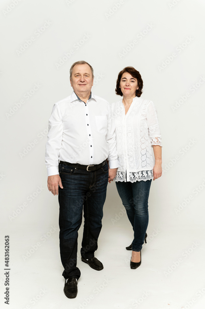 couple in national clothes on a white background. husband and wife in embroidered shirts. people of retirement age. couple in national clothes on a white background. husband and wife in embroidered shirts. people of retirement age.