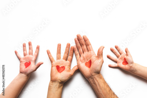 Family hand palms with red heart painted on them 