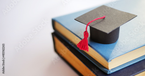 Graduation cap on stack of books. University degree concept 