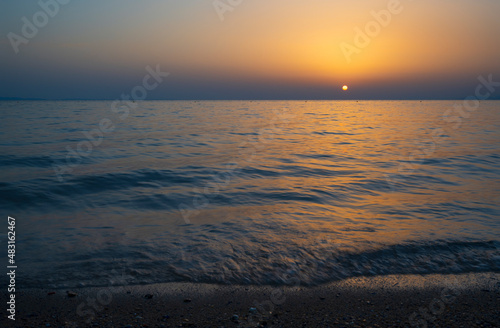 Tranquil scene of beautiful sea at sunset. Scenic seascape. Orange and yellow sunset on the sea. Aerial panoramic view of sunset over sea.