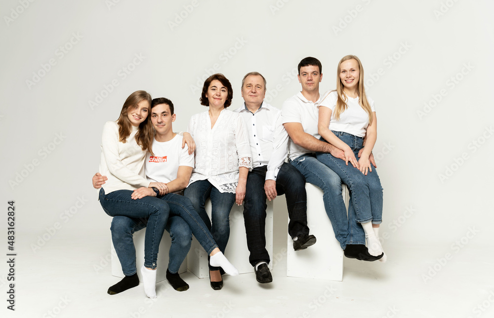 Obraz premium cheerful family on a white background. people of different ages and nationalities. family members. group portrait on white background