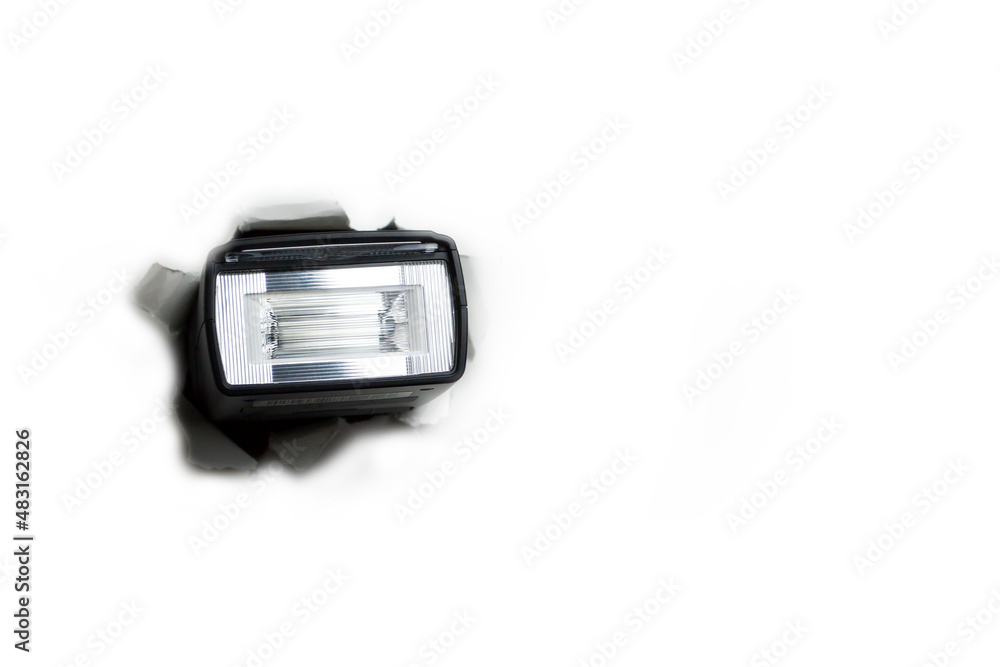 A flash sticks out of a hole on a white background.