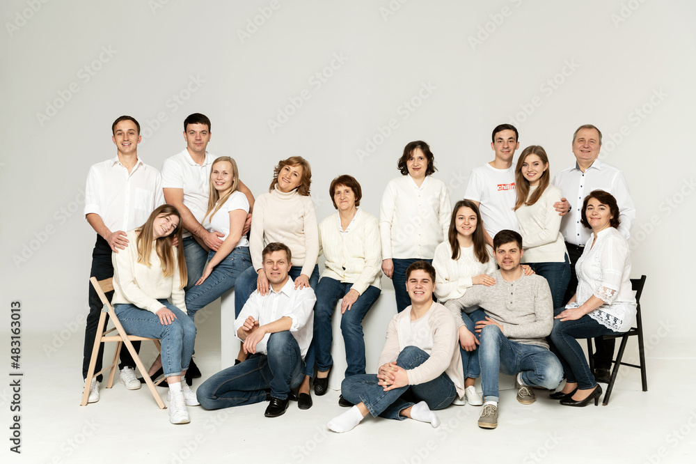 © Vadym - portrait of a large family on a white background. a large friendly family is dressed in red and black clothes. a group of people from different regions of the country. people of different ages © Vadym - portrait of a large family on a white background. a large friendly family is dressed in red and black clothes. a group of people from different regions of the country. people of different ages