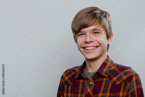 Emotional portrait of a teenager in a plaid shirt © HotPhotoPie