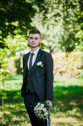Portrait of the groom on a green background