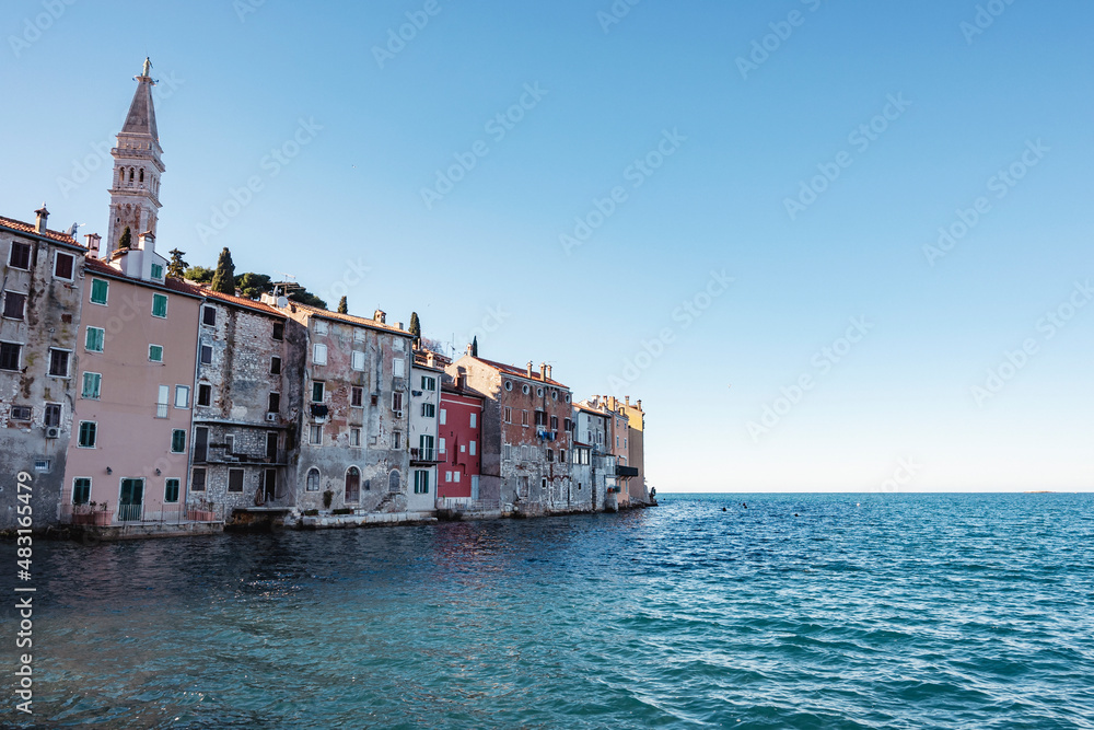 Beautiful Rovinj houses built right on the edge of the sea on the rocky peninsula above water