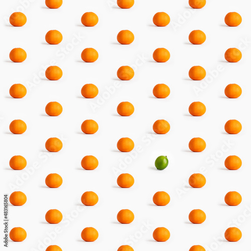 Seamless pattern of tangerines and one lime on a white background