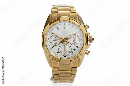golden women's wrist watch with diamonds and a metal bracelet and chronograph isolated on a white background close-up. Expensive and rich gift for women.
