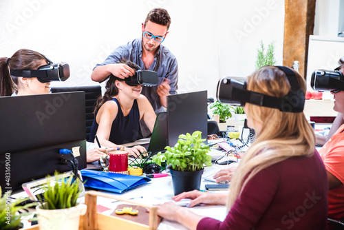 Young people employee workers having fun with vr virtual reality goggles in startup studio - Human resource business concept on milenials working time - Start up entrepreneur at office - Bright filter photo