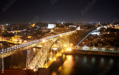 The illuminated Don Luis I bridge over River Douro at night in Porto, Portugal