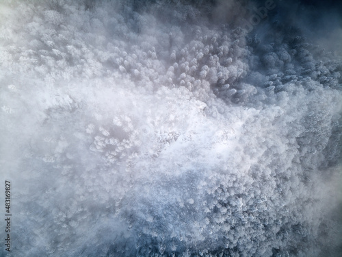 Top view of snowy conifer crowns. Nature pattern. Drone shot. © ASHarchenko