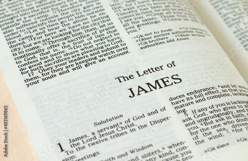 Apostle James epistle letter open Holy Bible Book close-up. New Testament Scripture. Studying the Word of God Jesus Christ. Christian biblical concept of love, faith, trust. photo