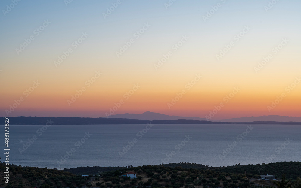 Tranquil scene of beautiful sea at sunset. Orange and yellow sunset on the sea. Aerial panoramic view of sunset over sea.