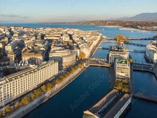 Aerial view of the Rhone river in the heart of Geneva old town and business district before reaching lake Geneva in Switzerland on a sunny fall day