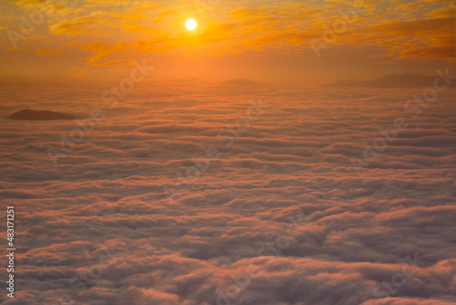 An early morning landscape with the sea of       clouds below and the morning sun rising