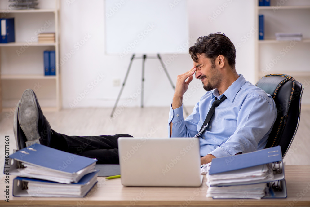 Young male employee working in the office Young male employee working in the office
