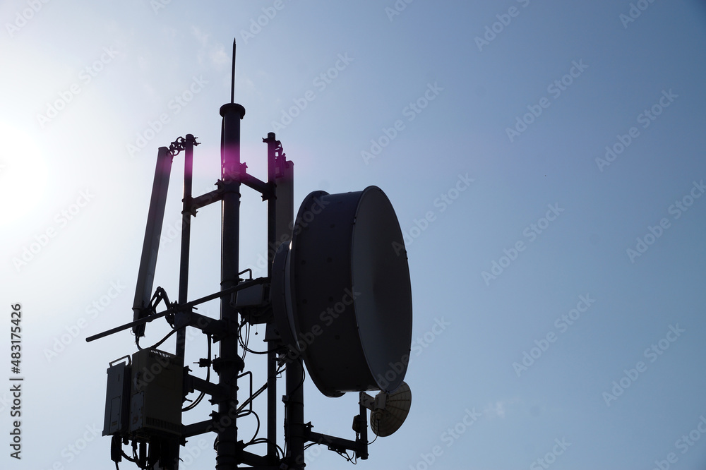 telecommunications antenna on the background of the sunny sky