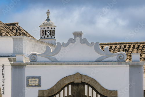 Close view of a traditional pediment and a traditional chimney in the village of Luz, Algarve, Portugal