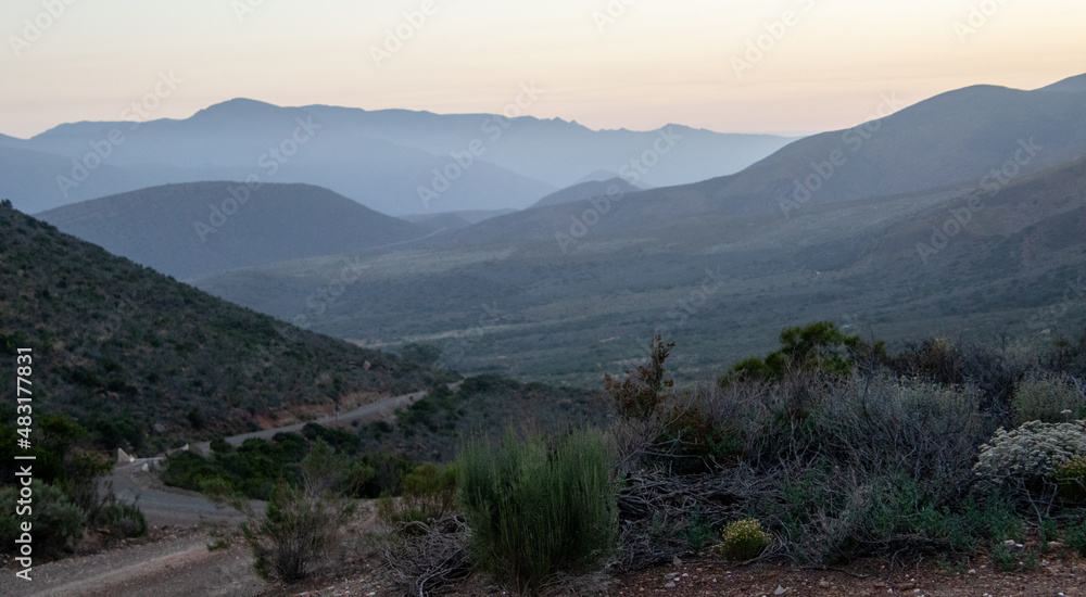 Fototapeta premium A valley of hills fade into the sunrise in Vleiland in the Central Karoo in the Western Cape province of South Africa