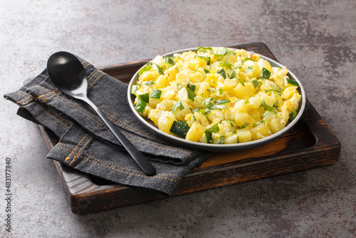 zarangollo spanish scrambled eggs with zuccini, traditional murciano tapas dish close up in the plate on the table. Horizontal photo