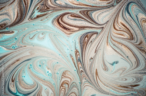 Marbleized effect. Natural Luxury. Liquid marble pattern with golden powder. Ancient oriental drawing technique.