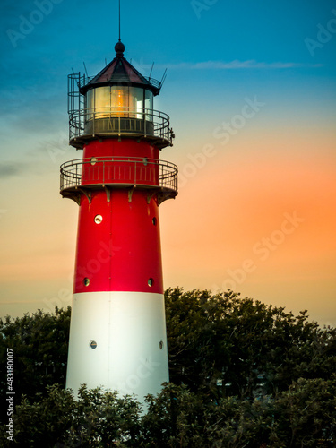 Lighthouse in the harbor on the North Sea at sunset