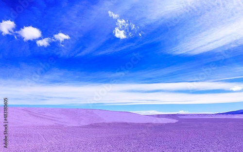 Beautiful surreal desert with purple sand dunes. Wilderness nature. Horizon. Incredible clouds sky. Adventure. Purple sand dunes in desert fairy planet  magical alien sandy landscape  blue sky.