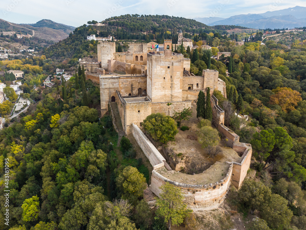 Dramatic aerial view of the Alhambra palace and fortress in Granada with the Torre de la Vela tower in Andalusia in southern Spain.