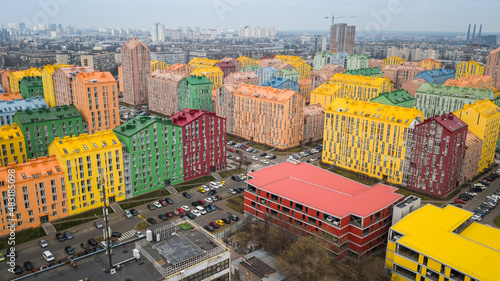 Canvas Print aerial view of colorful (red, green, blue, yellow) buildings on city street
