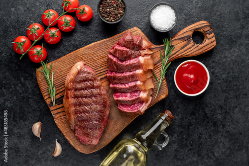 
grilled picanha steak with spices on a stone background
