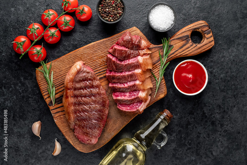 
grilled picanha steak with spices on a stone background
