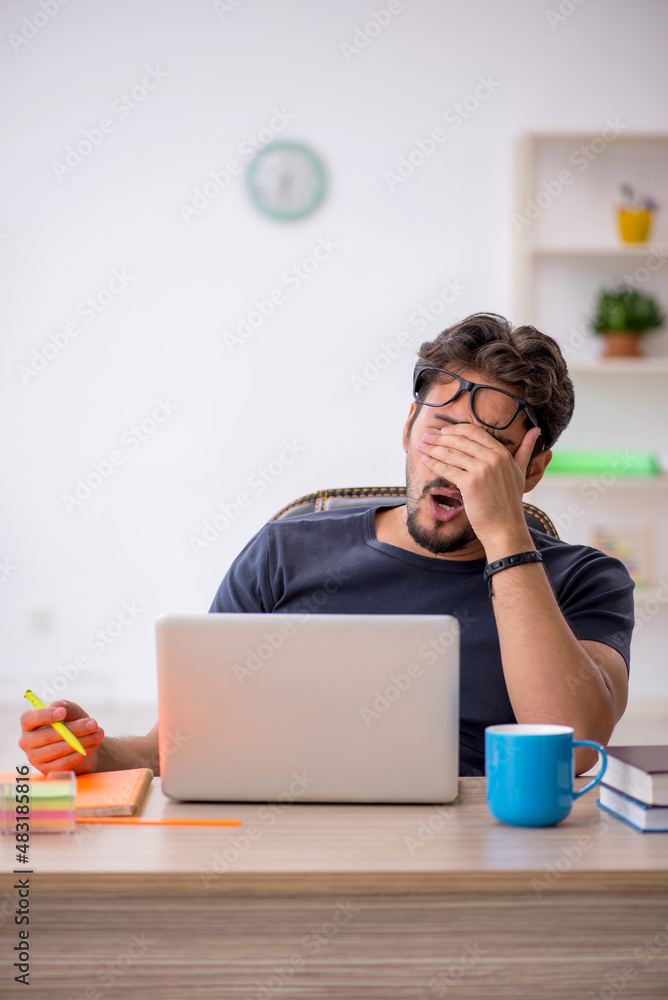Young male designer working in the office Young male designer working in the office