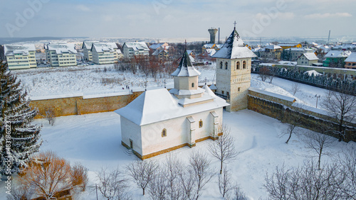 Aerial photography of Zamca monastery, located in Suceava county, Romania in winter season. Photography was taken from a drone with camera pointing downwards at a lower angle.