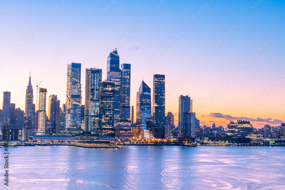 Fototapeta premium Vivid Manhattan skyline taken right before sunrise, wonderful architecture in low light, long exposure technique.