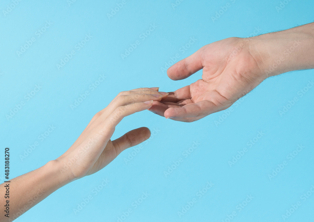 Hands diagonally reching to each other and fingers slightly touch Hands diagonally reching to each other and fingers slightly touch