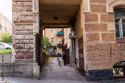 Man talking on the phone in an old courtyard