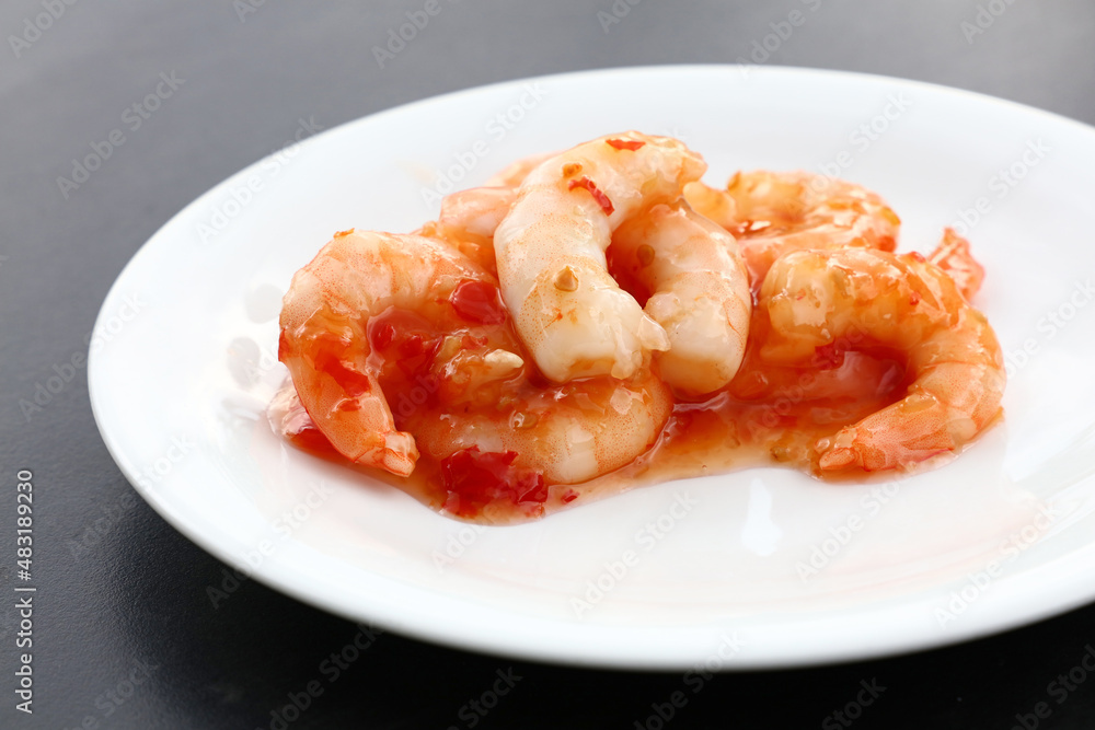 Portion of shrimps with chili sauce on plate Portion of shrimps with chili sauce on plate