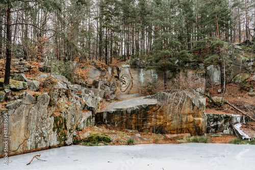 Rock relief called Bretschneiderovo ucho,Bretschneider ear, in forest near Lipnice nad Sazavou,Czech Republic.Tourist destination in Czech countryside.Colorful fall trees,outdoor modern art photo