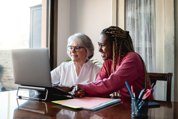 Multiracial senior and young business people with working inside modern office - Focus on old woman face