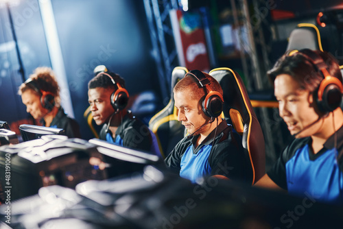Canvastavla Team of four professional cybersport gamers wearing headphones participating in