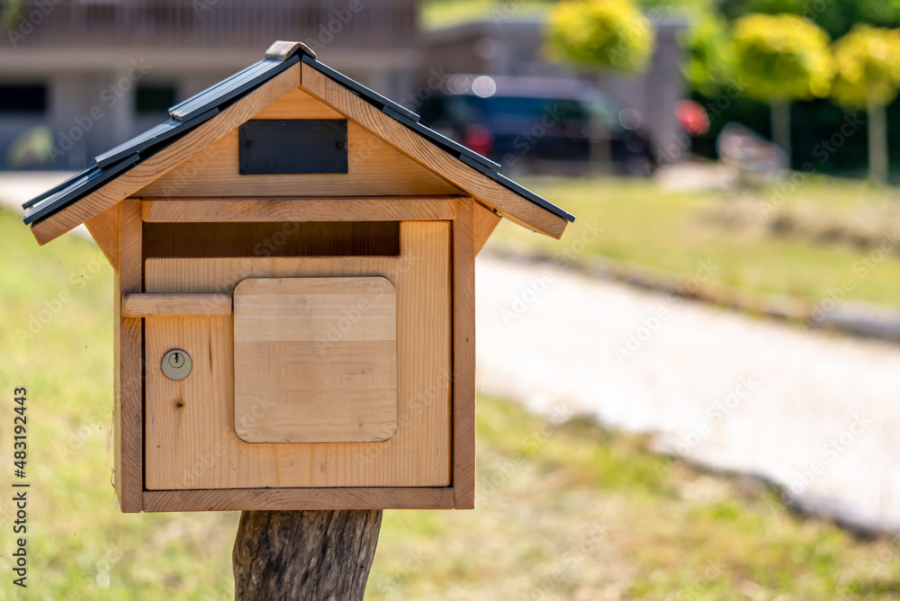 Wooden mail box with lock in garden. Wooden mail box with lock in garden.