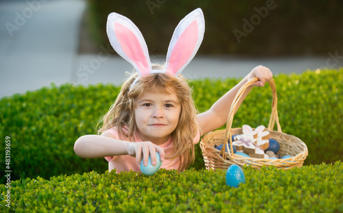 Happy easter bunny child boy. Spring kids holidays concept. Child gathering eggs, easter egg hunt concept.