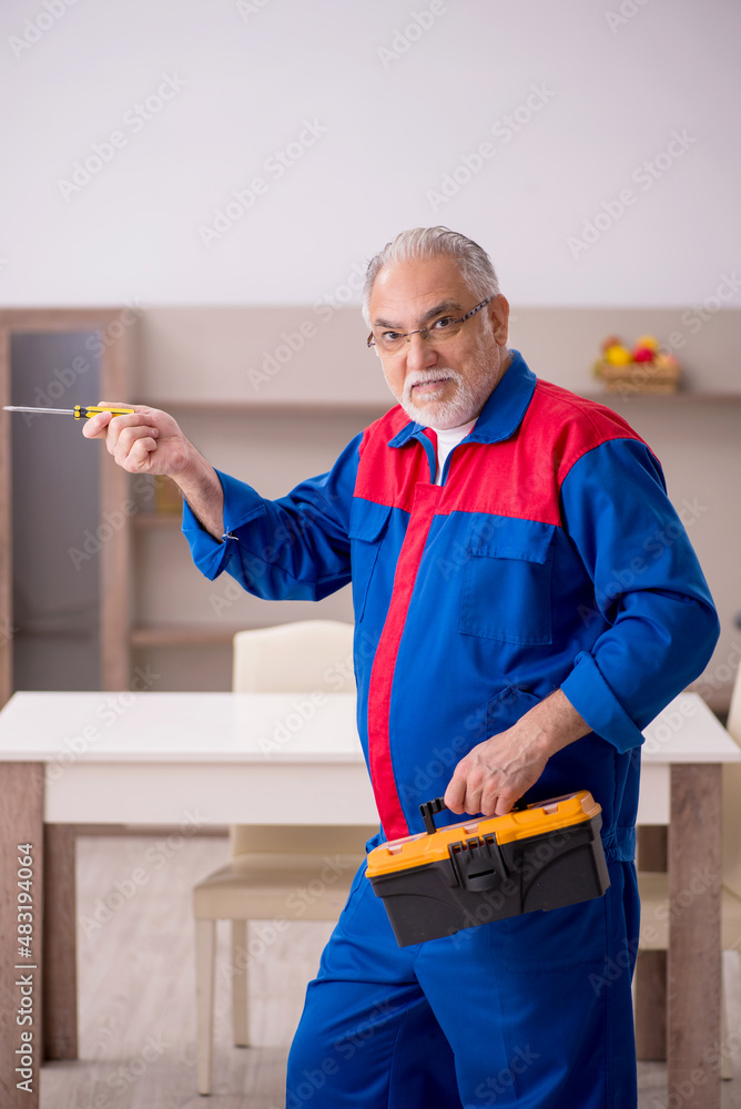 Old male carpenter working indoors Old male carpenter working indoors