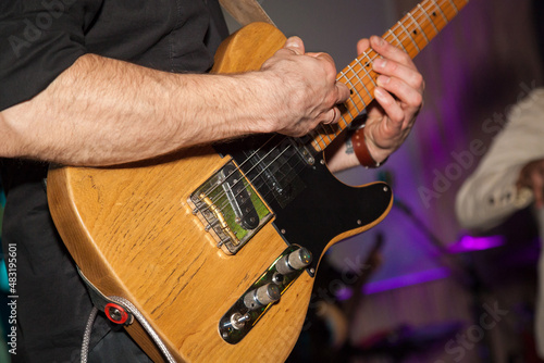 A man plays the guitar in close-up. Hands playing guitar close-up.