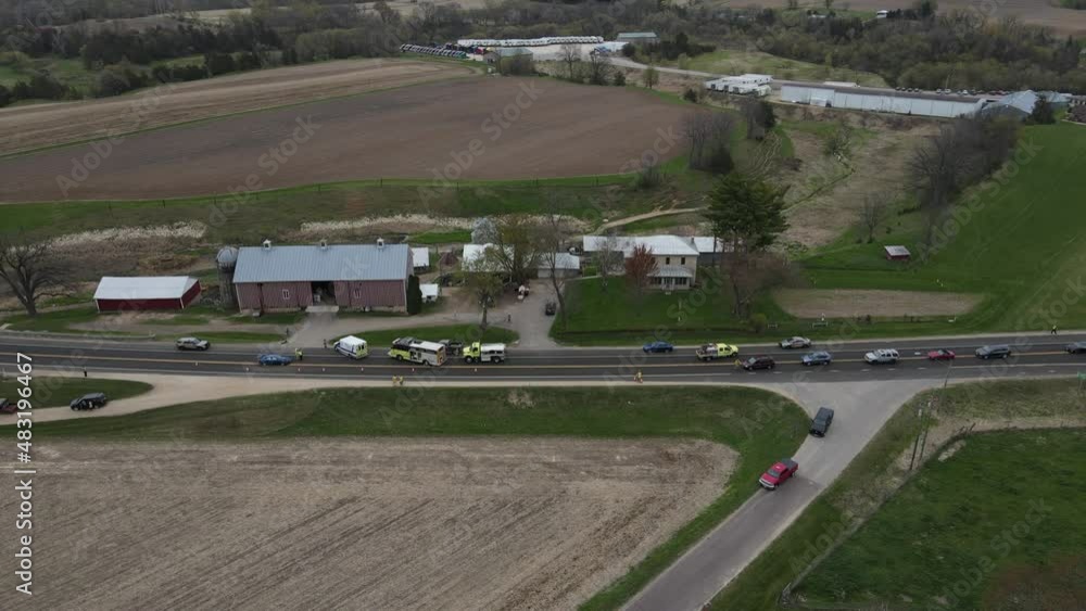 Aerial view of accident scene in front of a rural farm in valley in
